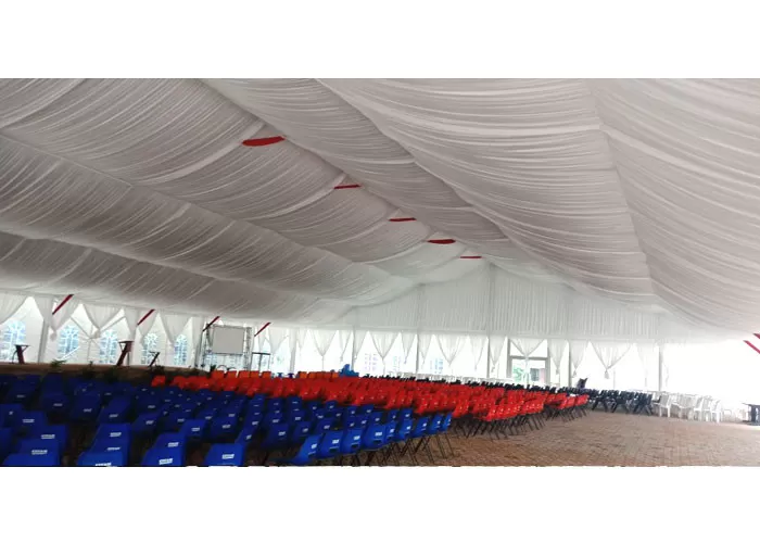 inside view of clear top church tent with stage and lighting for religious services