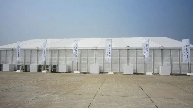 Angled exterior view of Lexus Exhibition Tent showing high peak and wide-span structure