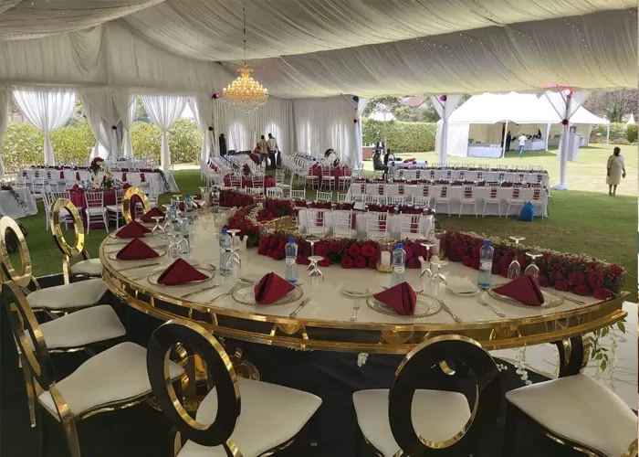 Romantic dance floor setup inside transparent wedding tent at night
