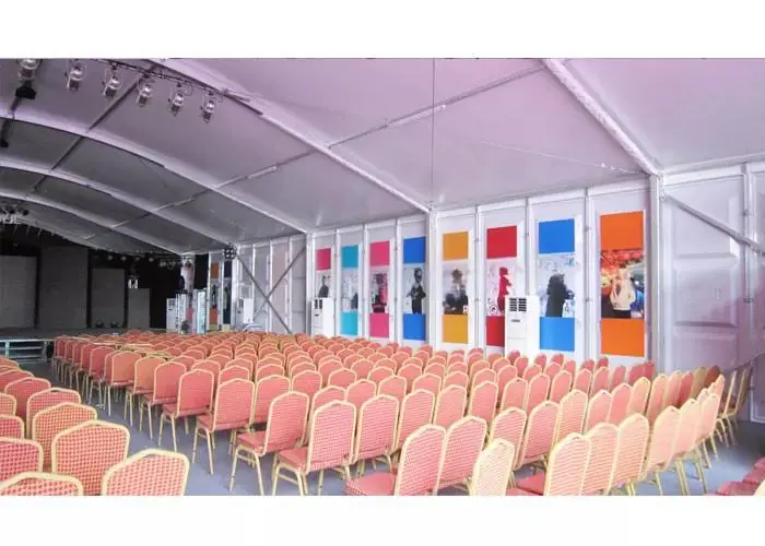 Executive summit setup inside business leadership tent with stage and lighting