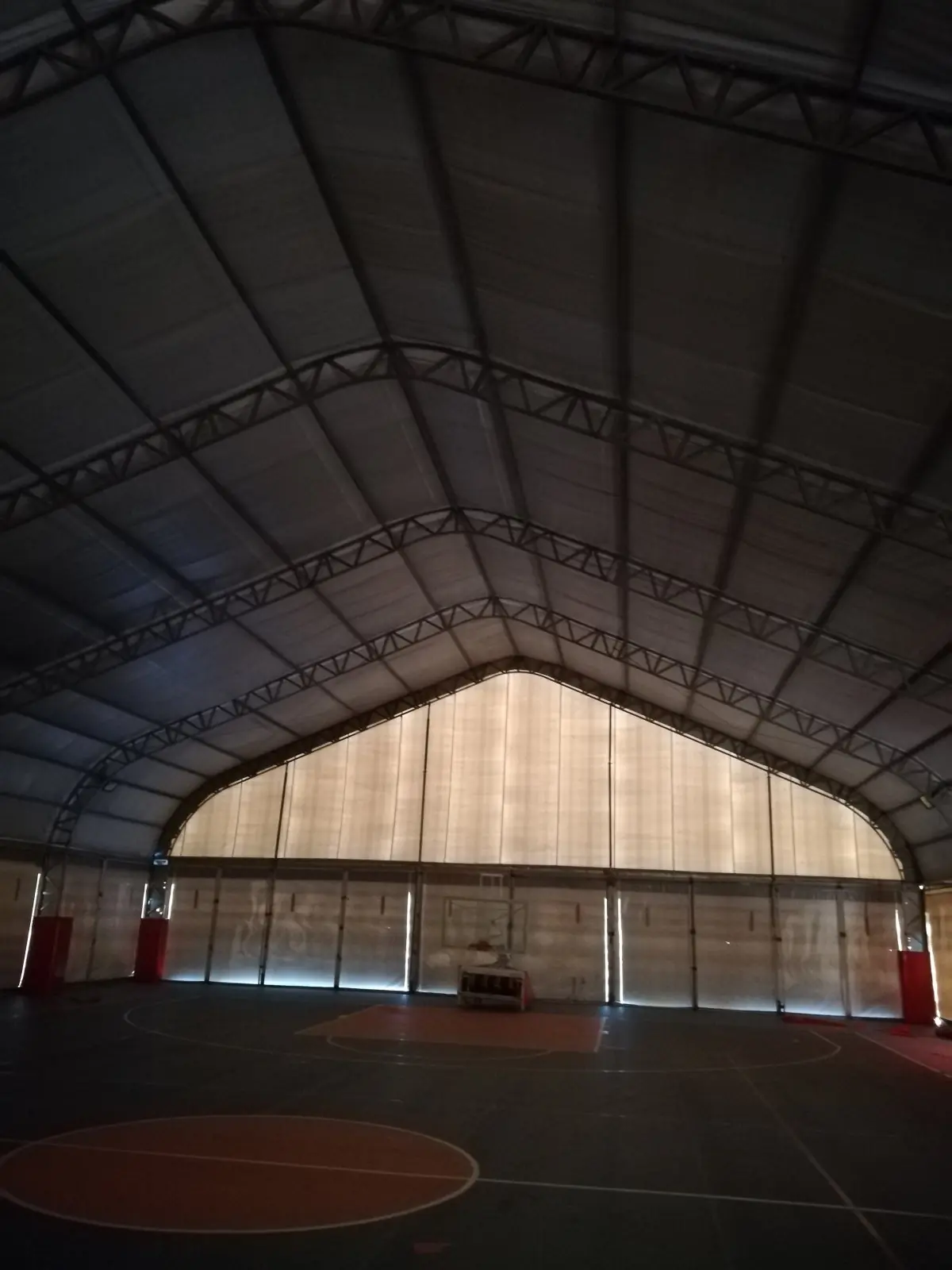 basketball court setup inside mobile sports tent structure