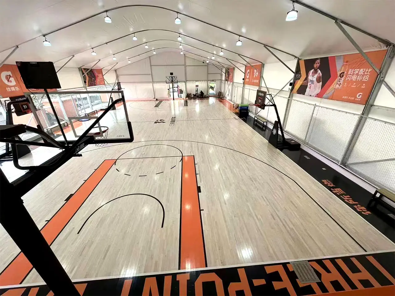 Wide-angle view of playing area inside Shenzhen modular basketball tent