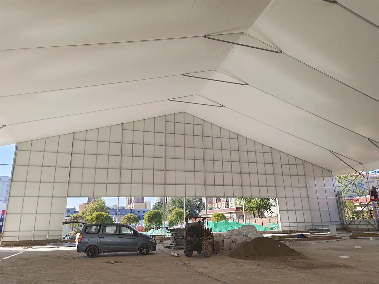 Interior of 60x120m American Basketball Tent during setup with basketball court installation