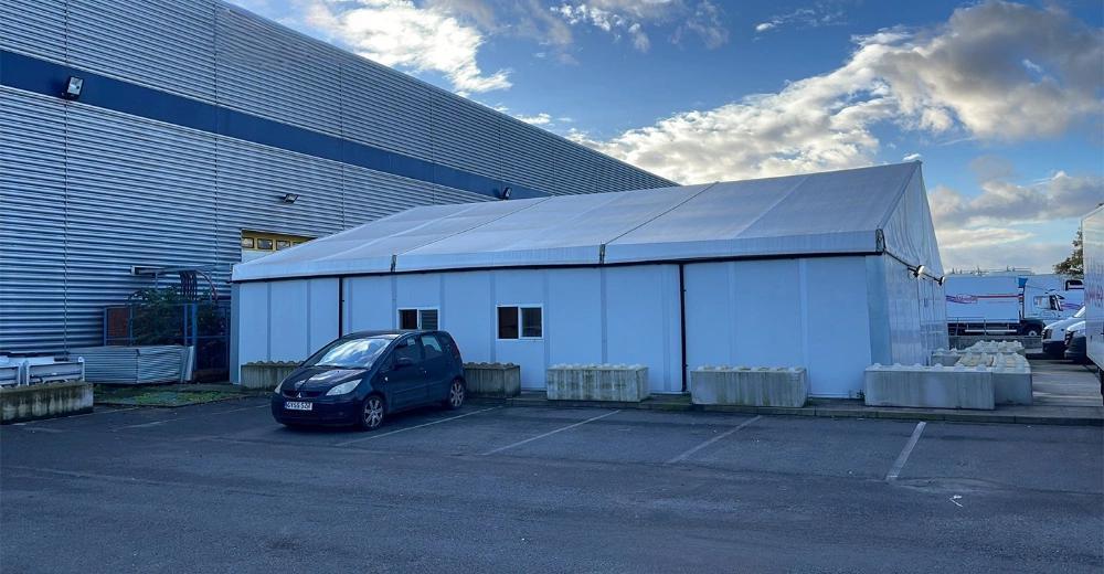 Outdoor perspective of 15x15m UK Workshop Tent showcasing aluminum frame design