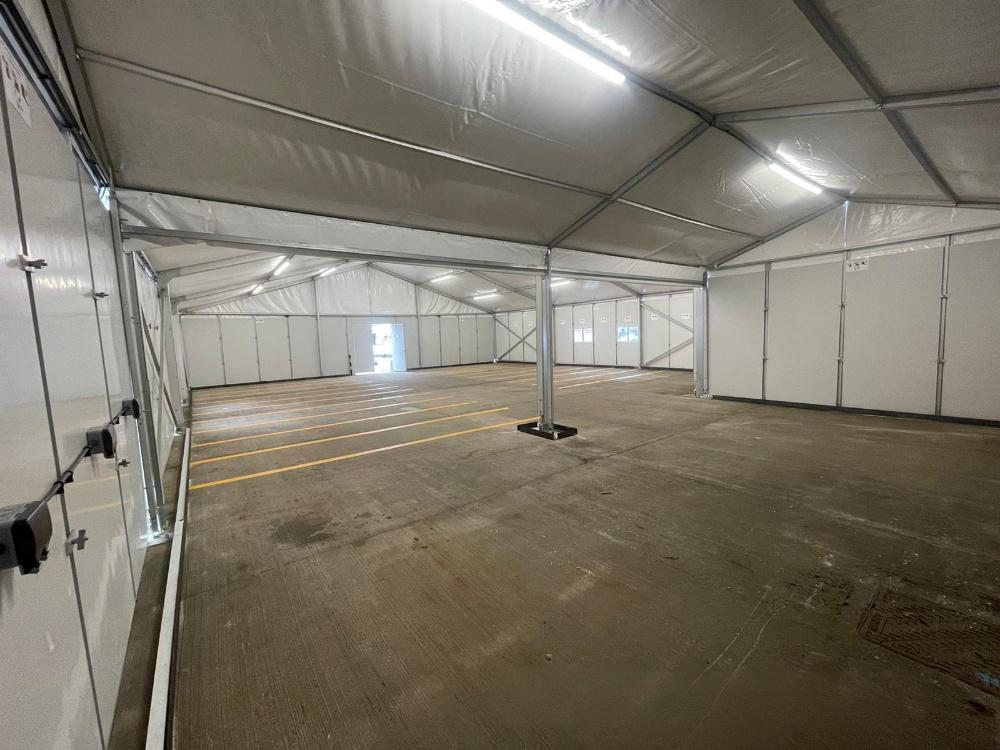 Inside view of 15x15m UK Workshop Tent during customization for storage use