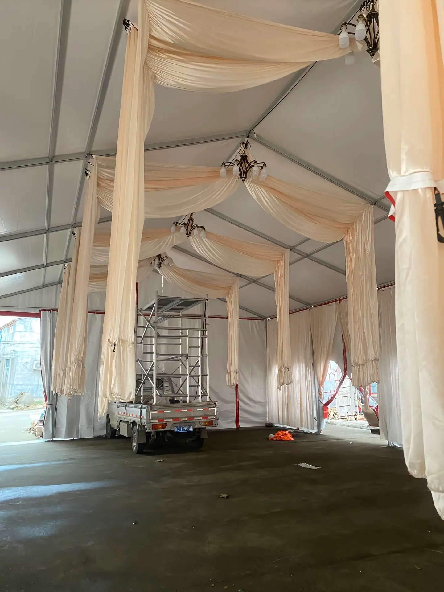Close-up of high-end interior decor inside Superb Holaj Tent’s 10x21m wedding tent, featuring white walls and decorative lighting