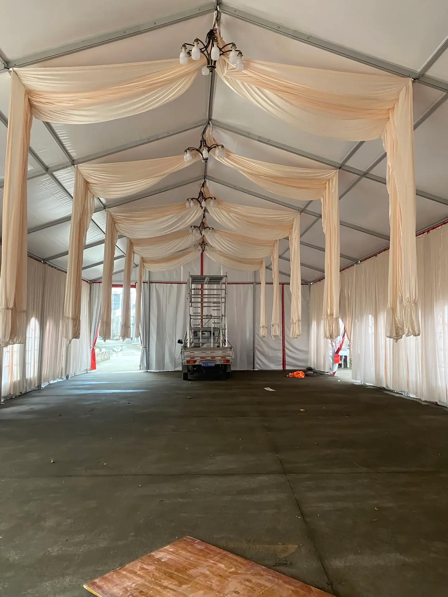 Wide-angle shot inside the luxury white marquee showing symmetrical seating and soft natural lighting