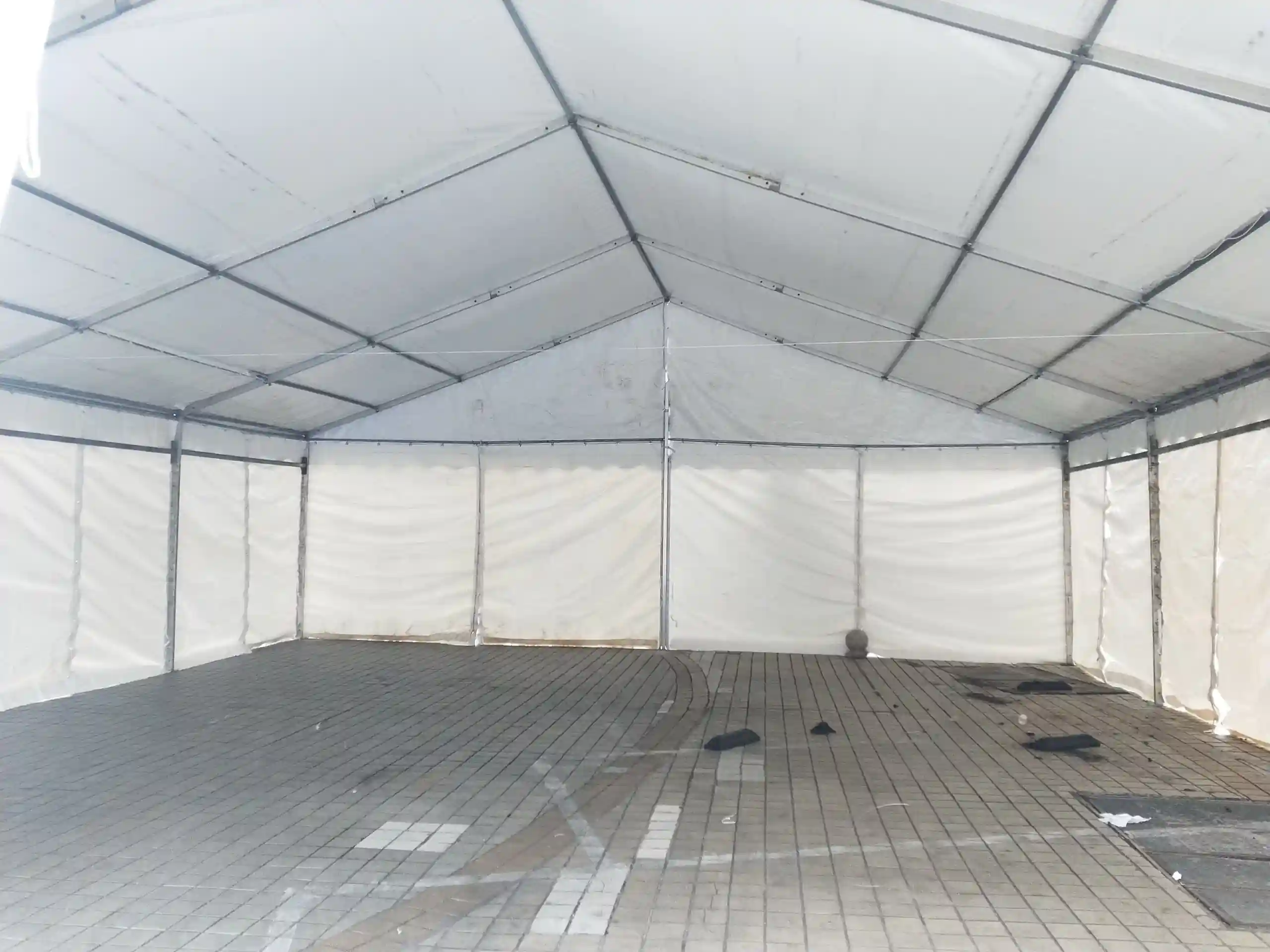 Spacious interior of 10x20m Italian wedding tent with customizable seating for 100.