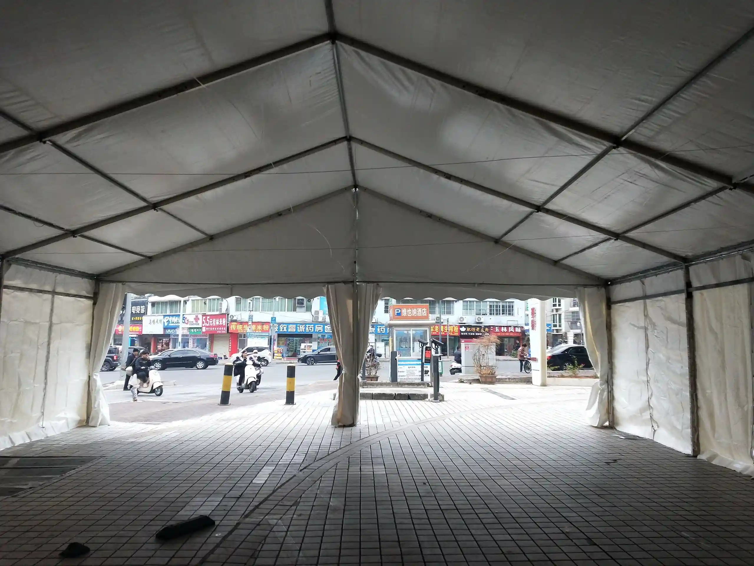 Bright 10x20m event tent interior with glass walls and A/C for elegant weddings.
