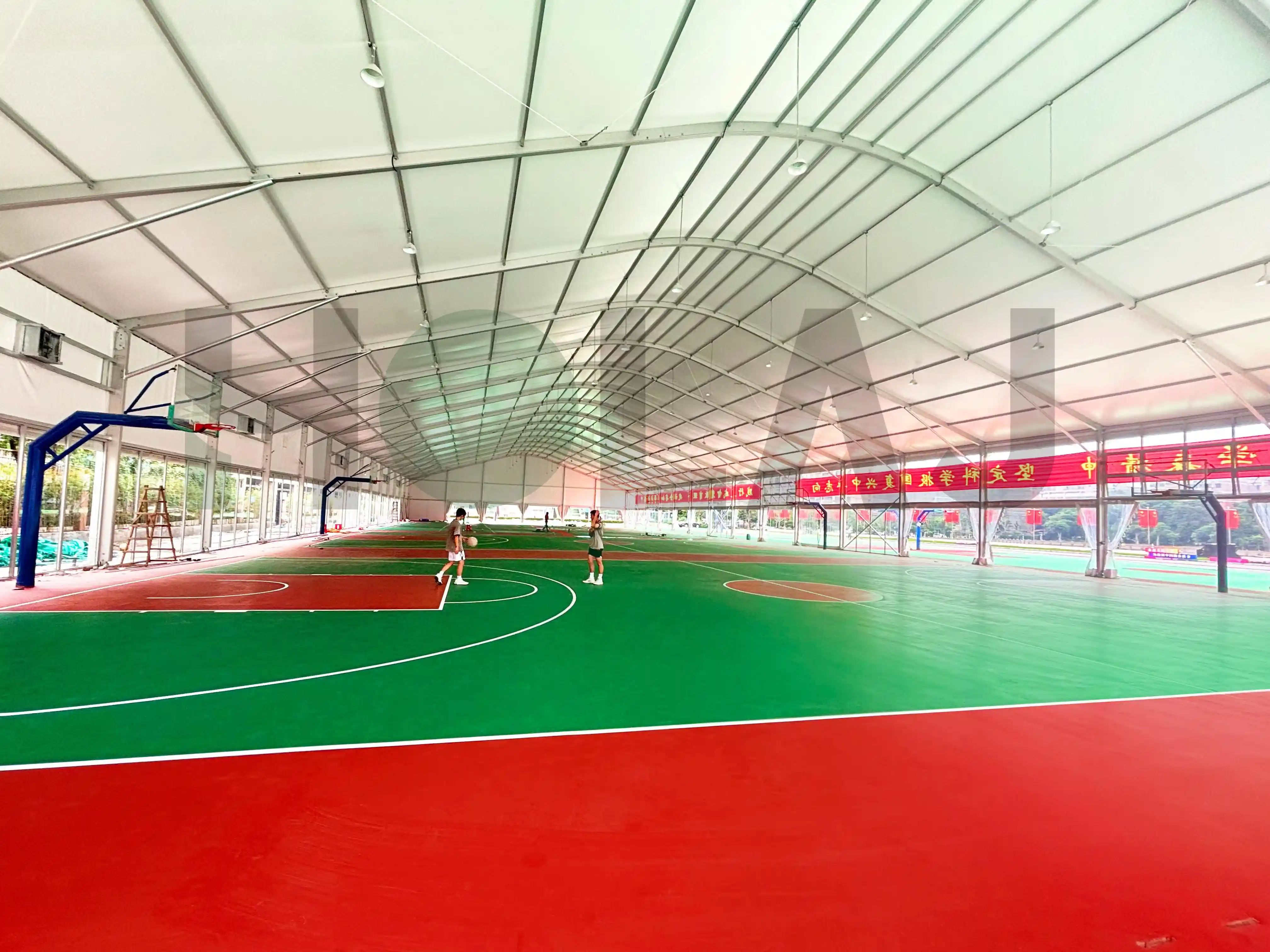 Wide-angle shot of indoor basketball court in modular sports structure